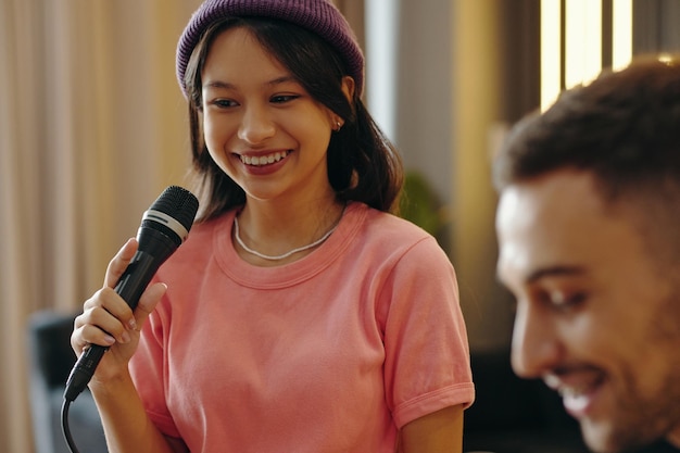 Professional singing lessons instructor teaching vocal techniques to student in music studio